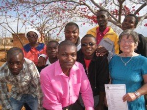 Seven members of Acworth United Methodist Church recently returned from a mission trip to Africa. Church members helped build a Hope Center in Zimbabwe and are planning a health clinic in Malawi. Church member Shirley Rose of Acworth stands with some of the representatives of the Hope Center. Dorothy Mutambara, back left, runs the Hope Center. The men are students who have graduated from the Hope Center. Some have graduated from college and have jobs, and others are still in college. The Hope Center and Acworth UMC helps support them with tuition, books, and other essentials. Most — if not all — are orphans whose parents died from HIV. (Photo courtesy of Cherokee Tribune)
