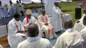 Bishop Michael Dixon Bhasera (background second from left) surrounded by newly ordained Catholic priests in Gweru (Photo K. Mavundutse)