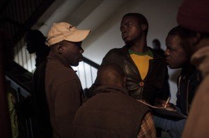 ***JOHANNESBURG, SOUTH AFRICA - JULY 24: A group of men take notes of who is and is not returning back to Zimbabwe to vote in the last week's election on the 31st of July at the Wednesday night service at the Central Methodist Church of South Africa, which 80% of people in attendances are Zimbabwean. Photo: Charlie Shoemaker
