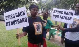 Itai Dzamara's wife, Sheffra Dzamara, kid and Dzamara's brother Patson Dzamara. (Photo: Gerald Chateta).